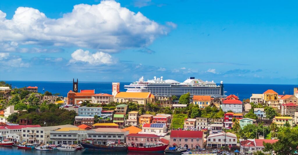 Vibrant harbor view in St. George's, Grenada with colorful buildings and boats under a bright blue sky.
