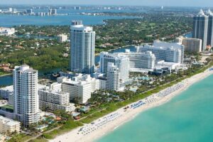 Stunning aerial view of Miami Beach's skyline along the Atlantic Ocean, ideal for travel and adventure imagery.
