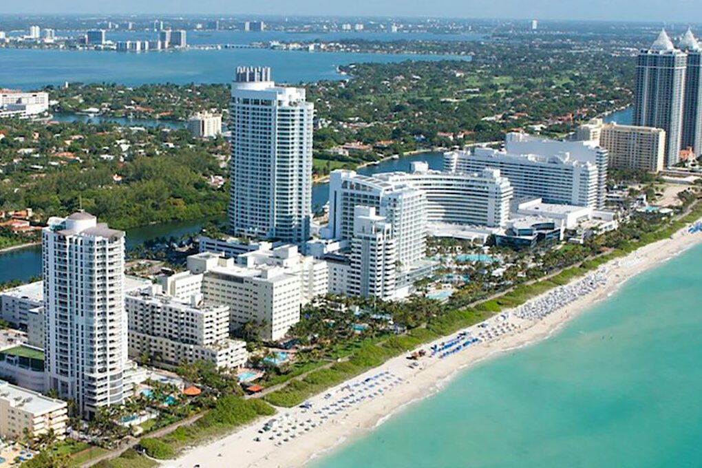 Stunning aerial view of Miami Beach's skyline along the Atlantic Ocean, ideal for travel and adventure imagery.